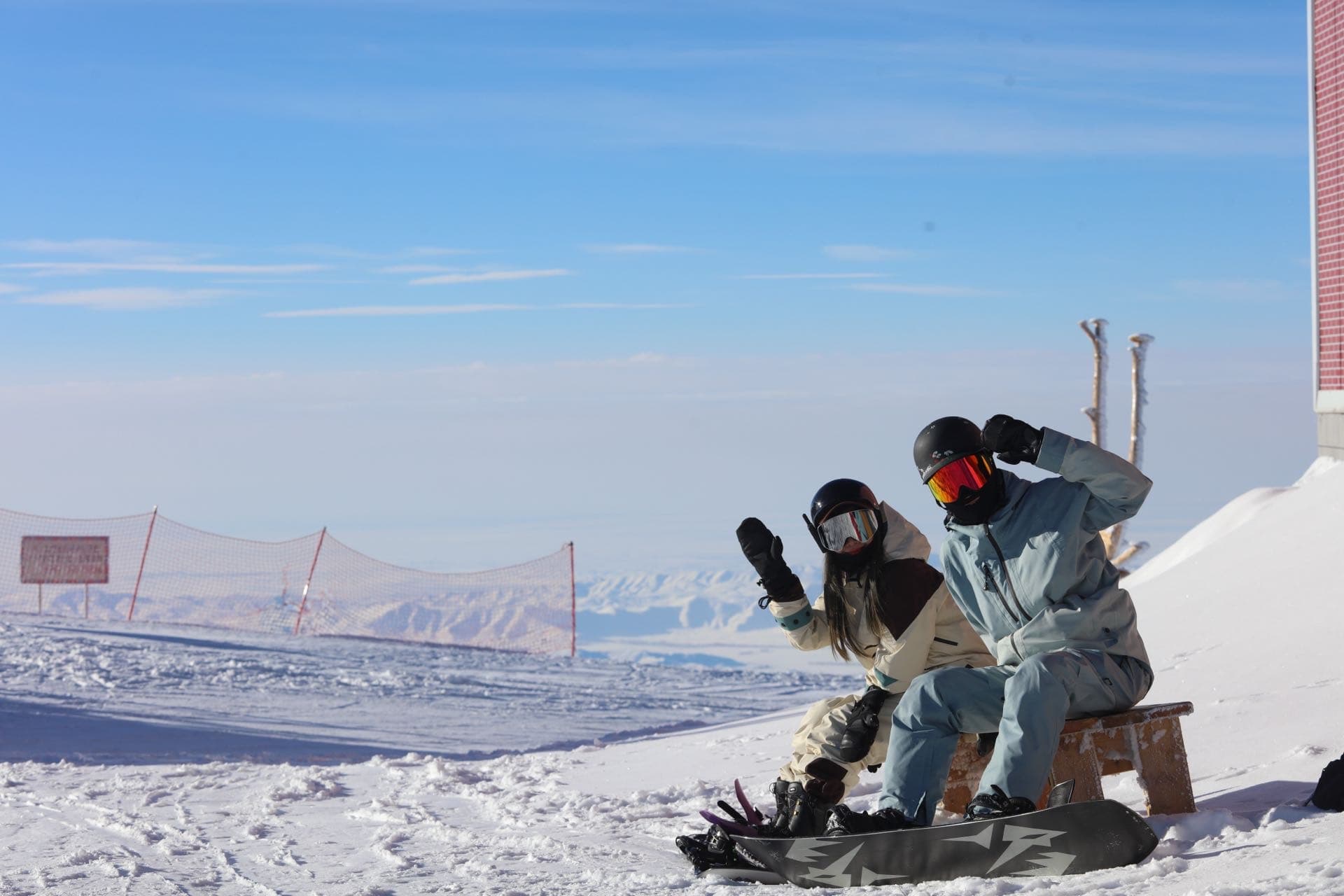 Snowboard lesson on a bright blue-sky day