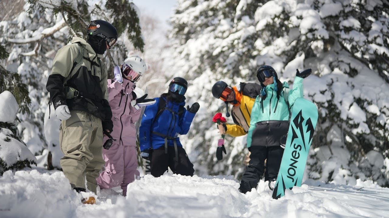 A ski and snowboard group in a snowy Hokkaido forest